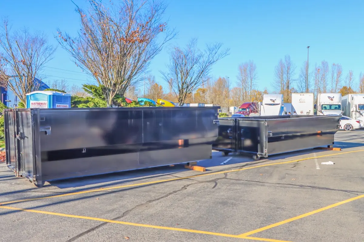 Professional dumpster rental service with roll-off container on residential driveway in Maywood